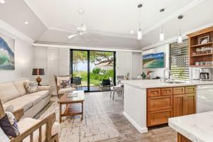 a kitchen and living room with a couch and a table at Kiahuna 183 Ground Floor Ocean View PBAC in Koloa