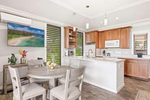 a kitchen with a table and chairs in a kitchen at Kiahuna 183 Ground Floor Ocean View PBAC in Koloa +43 photos