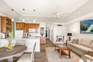 a kitchen and living room with a couch and a table at Kiahuna 183 Ground Floor Ocean View PBAC in Koloa