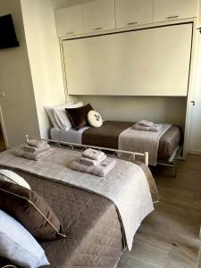 a bedroom with two beds and a large mirror at Sea Breeze Suites in Livorno