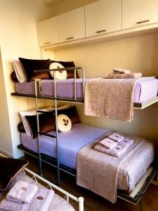 a room with three bunk beds in a room at Sea Breeze Suites in Livorno