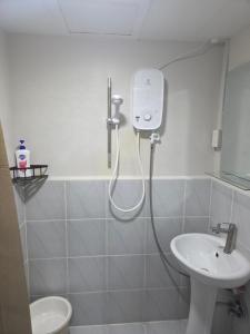 a bathroom with a shower and a sink at Pinili Homestay in Suba +9 photos
