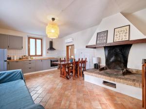 a kitchen with a fireplace and a table and chairs at Selvuccia Lodge - Ostello Agricolo in San Piero a Sieve +41 photos