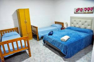 a bedroom with two beds and a yellow cabinet at Las Magnolias in Embalse