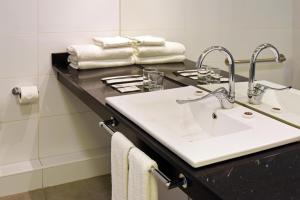 a bathroom with a sink and a mirror at Hotel HW Libertad in Santiago +38 photos