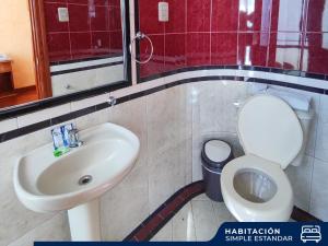 a bathroom with a toilet and a sink at Hotel Diamante Azul in La Paz +58 photos