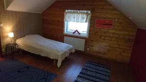 A bed or beds in a room at Lapland Snow Cabin