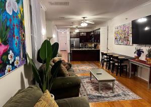 a living room and kitchen with a couch and a table at Spacious Napoleon Ave Condo in New Orleans