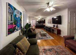 a living room with a couch and a dining room at Spacious Napoleon Ave Condo in New Orleans +15 photos