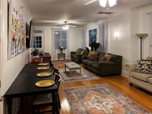 a living room with a table and a couch at Spacious Napoleon Ave Condo in New Orleans