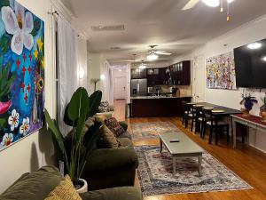 a living room with a couch and a table at Spacious Napoleon Ave Condo in New Orleans