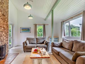 a living room with a couch and a fireplace at 2 Bed in Saltash oc-95642 in Wotter