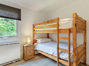 a bedroom with two bunk beds and a window at 2 Bed in Saltash oc-95642 in Wotter
