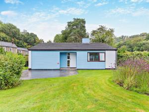 a blue and white house with a yard at 2 Bed in Saltash oc-95642 in Wotter