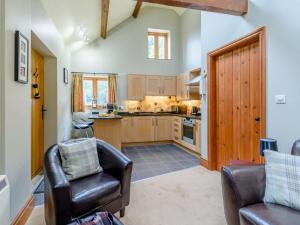 a kitchen with two leather chairs and a table at 1 Bed in York oc-83265 in High Catton