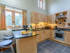 a kitchen with wooden cabinets and a counter top at 1 Bed in York oc-83265 in High Catton