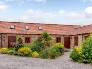 an old brick house with a garden in front of it at 1 Bed in York oc-83265 in High Catton +5 photos