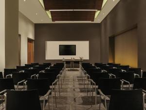 a conference room with chairs and a screen at ibis Kochi City Centre - An Accor Brand in Cochin