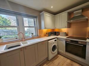 a kitchen with a sink and a washing machine at 1 Bed in Duns oc-83140 in Duns