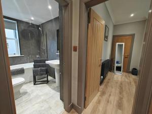 a bathroom with a toilet and a sink and a tub at 1 Bed in Duns oc-83140 in Duns +10 photos