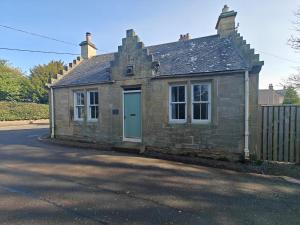 an old stone house with a blue door at 1 Bed in Duns oc-83140 in Duns
