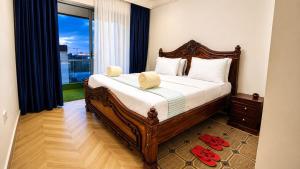 a bedroom with a large bed and a large window at Desired Atmosphere Safaris in Nairobi +27 photos