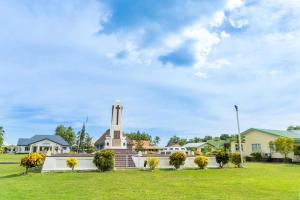 a building with a clock tower in a park at Vunakavika House - Village Stay in Nadi