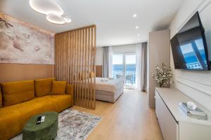 a living room with a couch and a bed at Skalinada Sea View in Lokva Rogoznica