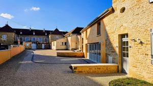 a building with a gate in the middle of a street at La Valdonnière in Esnoms-au-Val