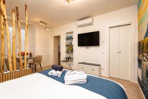 a bedroom with a bed and a tv on a wall at 2 passi dal lago, Como Lake in Abbadia Lariana
