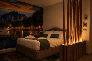 a bedroom with a bed with a painting on the wall at 2 passi dal lago, Como Lake in Abbadia Lariana +12 photos