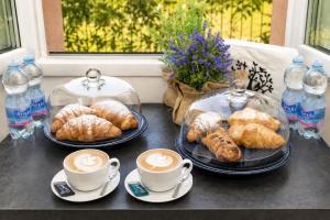 a table with two cups of coffee and pastries at 2 passi dal lago, Como Lake in Abbadia Lariana