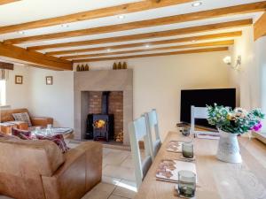 a living room with a couch and a fireplace at 2 Bed in Belper oc-74965 in Crich