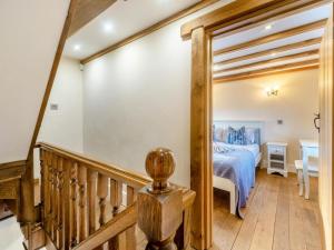 a staircase leading to a bedroom with a bed at 2 Bed in Belper oc-74965 in Crich