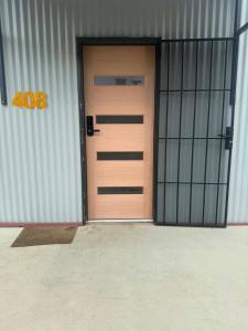 a wooden door in a building with the number at The Shed Bed & Breakfast in Hay
