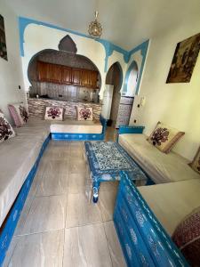 a living room with two beds and a fireplace at Casa Barkouk Central Chefchaouen Apartment in Chefchaouen
