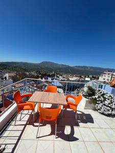 a patio with a table and chairs on a roof at Casa Barkouk Central Chefchaouen Apartment in Chefchaouen