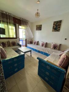 a living room with two beds and a couch at Casa Barkouk Central Chefchaouen Apartment in Chefchaouen