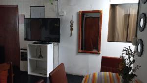 a living room with a tv and a mirror at casa posada paracas in Paracas +6 photos