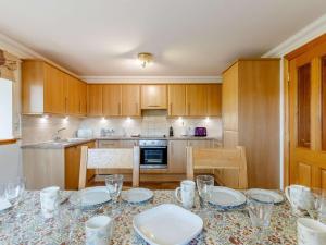 a kitchen with a table with plates and glasses on it at 2 Bed in Perth oc-86059 in Forgandenny