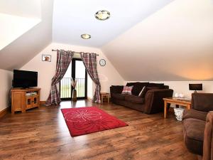 a living room with a couch and a red rug at 2 Bed in Perth oc-86059 in Forgandenny