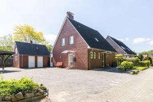 a large red brick house with a driveway at Lieblingsplatz in Lathen