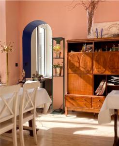 a dining room with a table and a wooden dresser at Maison Georges in Tourcoing