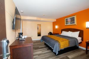a hotel room with a bed and a flat screen tv at Indian Mound Motel in Fairmont City