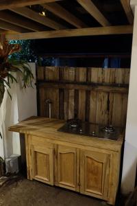 a wooden counter with a sink in a room at Jagadhita Villas in Sekatonan