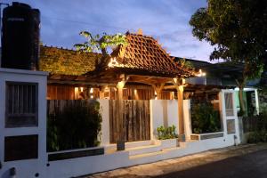 a house with a gazebo at night at Jagadhita Villas in Sekatonan