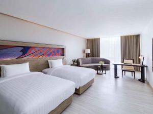 a hotel room with two beds and a desk at Novotel Phuket City Phokeethra in Phuket +254 photos