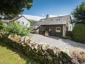 an old stone wall in front of a cottage at 3 Bed in Keswick oc-sz328 in Applethwaite