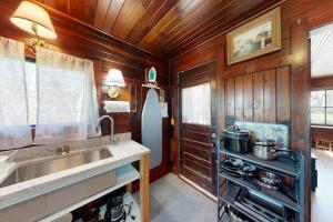a kitchen with a sink and a stove at The Pinkletink in Oak Bluffs