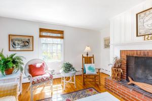 a living room with a fireplace and a couch at Edgartown Cozy Corner in Edgartown